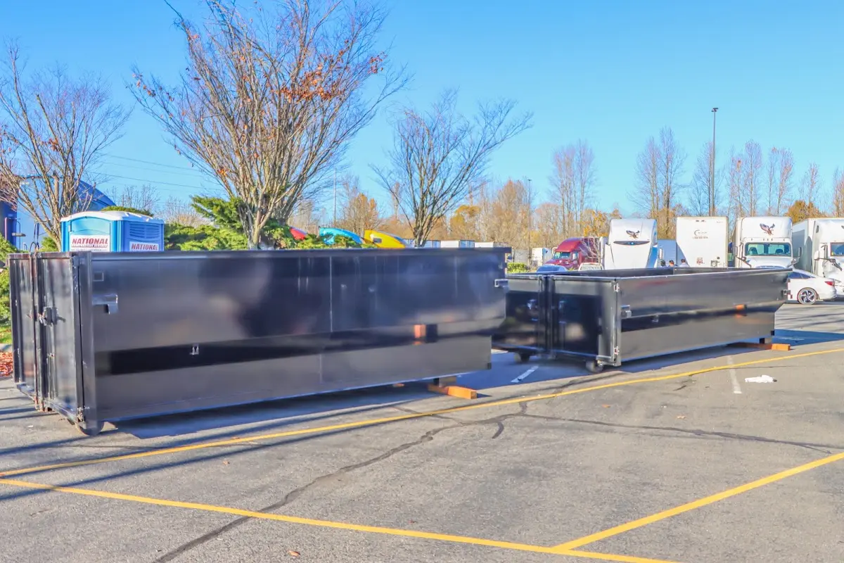 Professional dumpster rental service with roll-off container on residential driveway in Kemp Mill